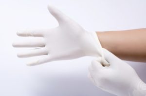 Gloved hands, symbolizing the precise, focused scope of network micropolicy for microservices