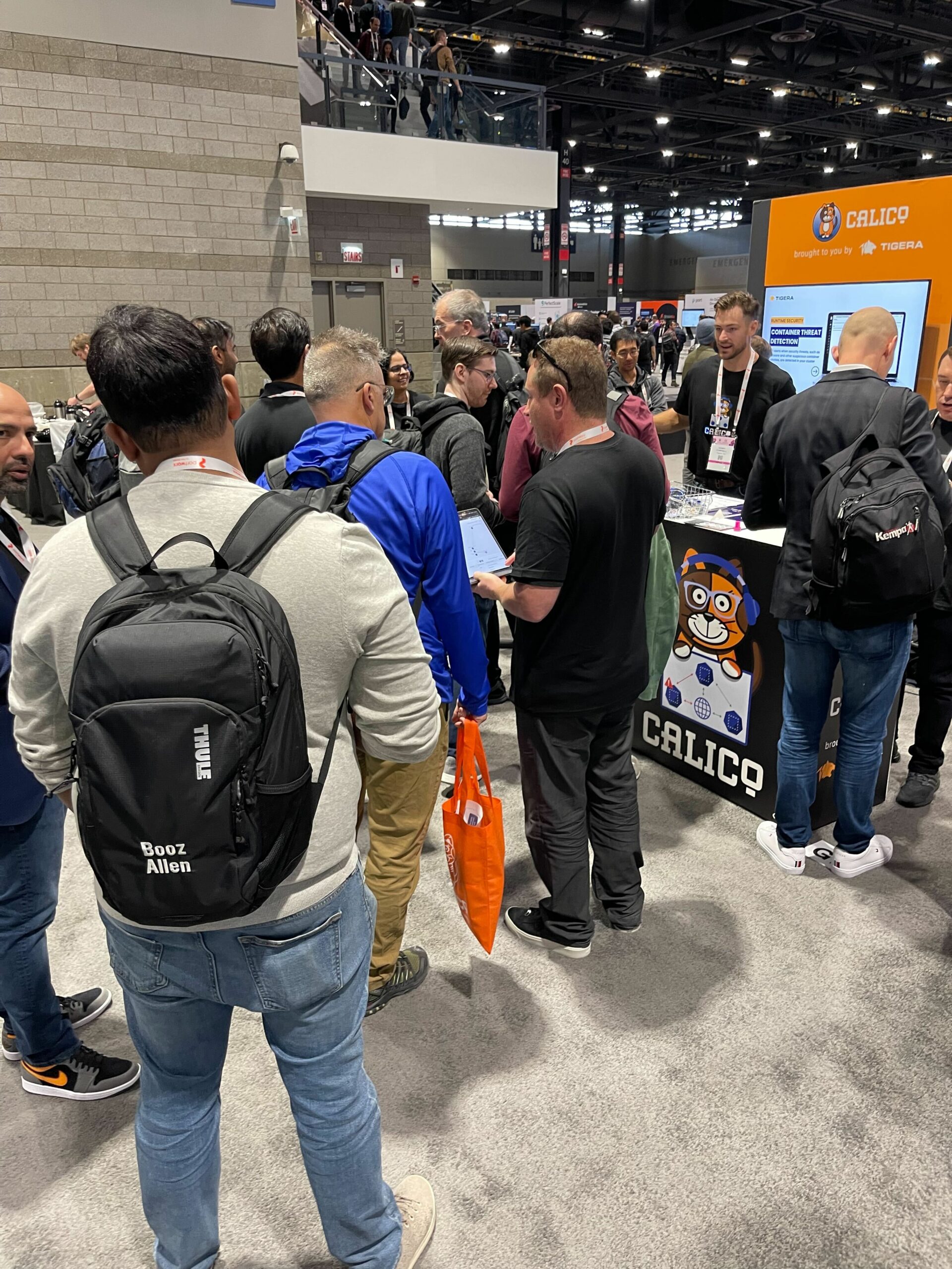 Crowd at booth, focusing on practical tech like fixed IPs, not architectural debates. Calico booth visible