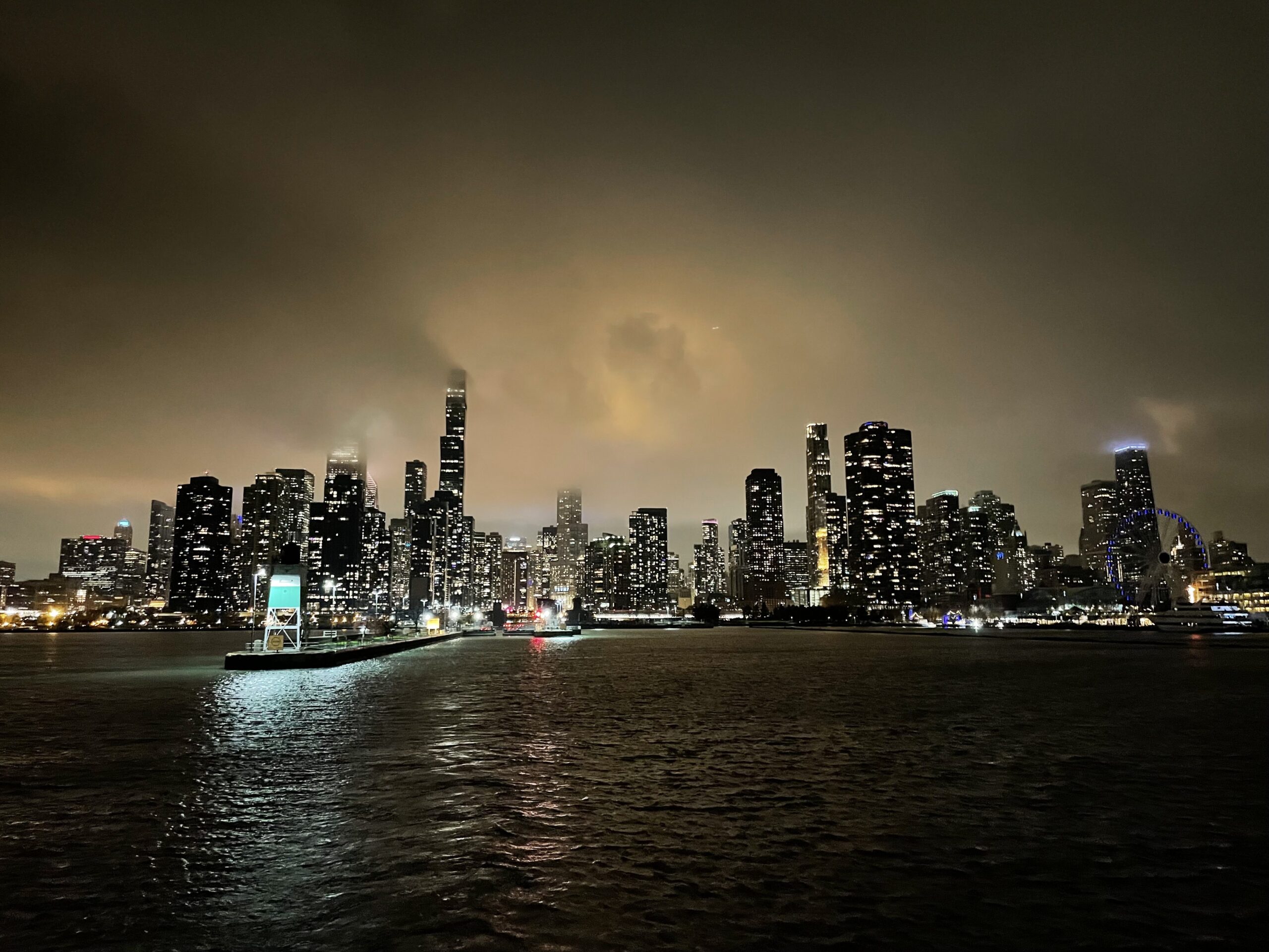 Night view of the Chicago skyline from the lake, showcasing the architecture enjoyed on our private cruise