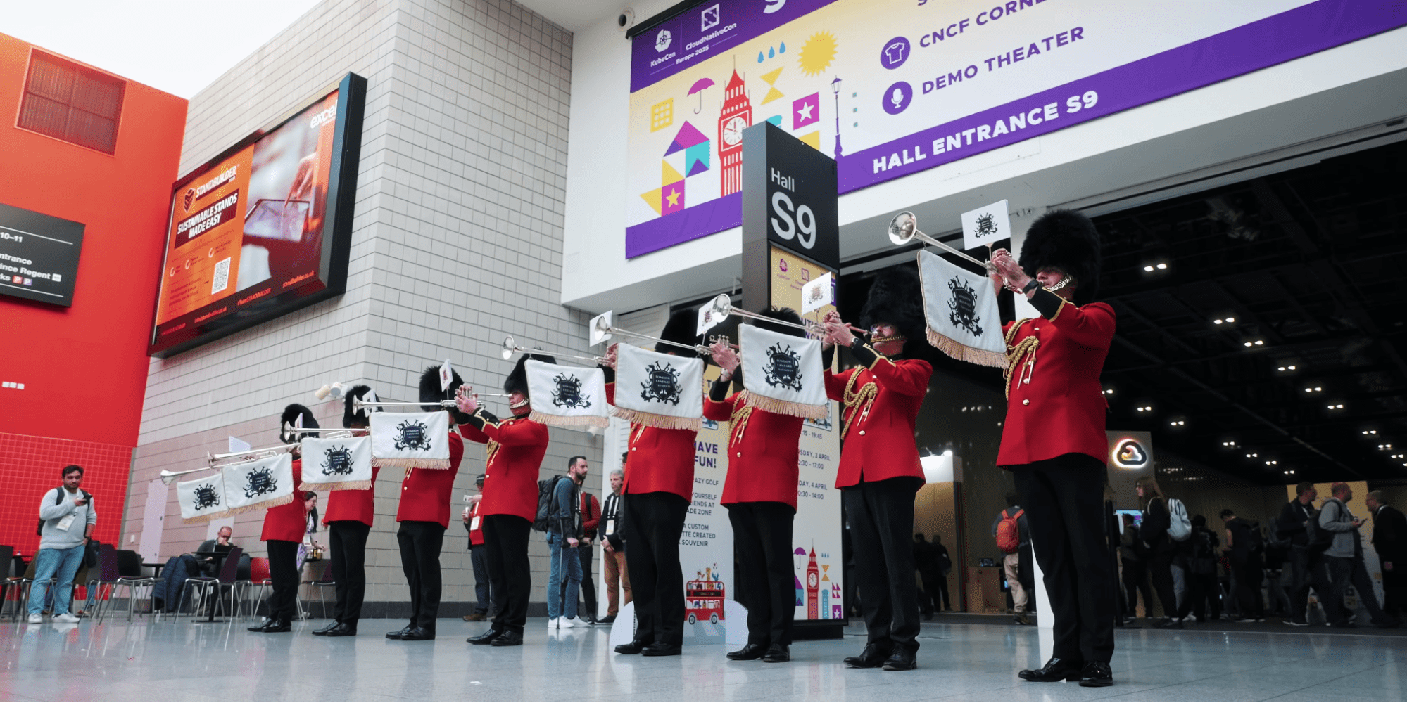 British Royal Guards play trumpets at a KubeCon event.