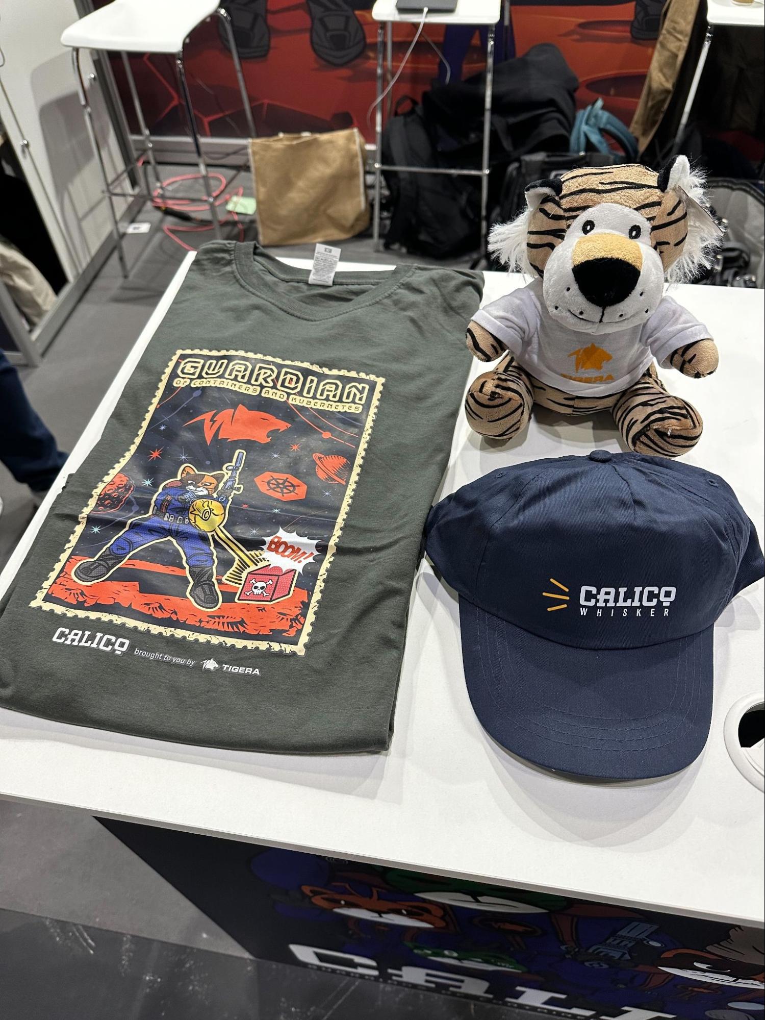 Calico branded t-shirt, plushie, and hat displayed at KubeCon.